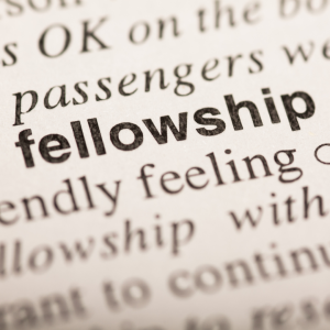 Close-up of the word 'fellowship' in a dictionary, focused on the entry.