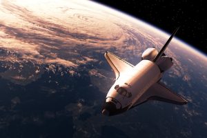 Space shuttle orbiting above Earth with a view of the curved planet below.