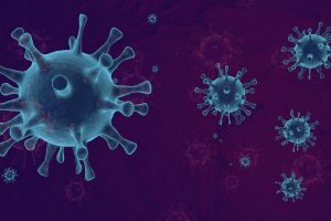 Blue coronavirus-like virus particles floating against a dark purple gradient background.